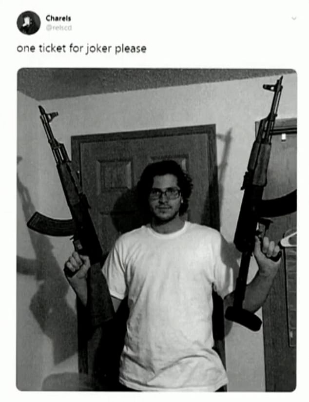 Donnelly poses with two AK-47s in a reference to a meme relating to "Joker," which got him red flagged