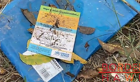 Dirty UN pamphlet in pile of trash
