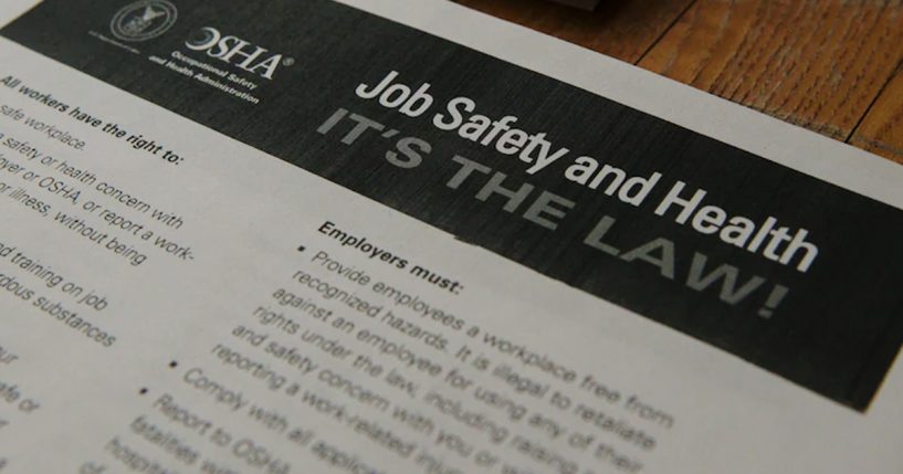 Piece of paper with OSHA's logo and "Job safety and health it's the law"